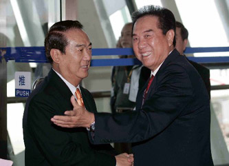 Chen Yunlin (R), director of the Taiwan Work Office of the Communist Party of China (CPC) Central Committee, greets James Soong, Chairman of the People First Party (PFP) in Taiwan, upon his arrival at Pudong airport of Shanghai, Sept. 14, 2005. Soong left Taipei for the Chinese mainland city Shanghai Wednesday morning to attend the first session of a non-governmental forum of elites from both sides of the Taiwan Strait.2