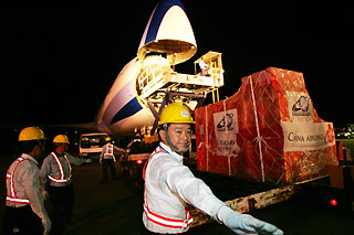 Airport workers load up a cargo plane from China Airlines, Taiwan’s largest air carrier, at Taiwan’s international airport in Taipei July 19, 2006.